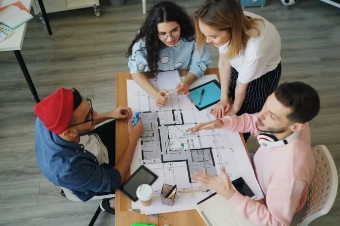 Homeowners planning building work reviewing plans